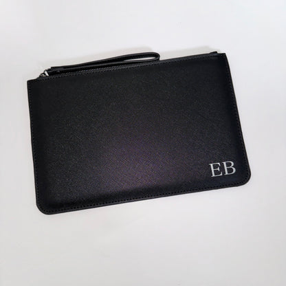 Black clutch bag with personalised initials on the bottom right side