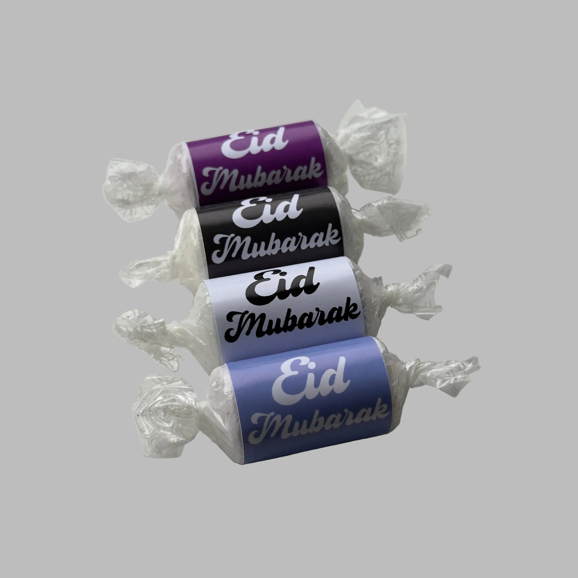 Love heart with 'Eid Mubarak' labels with bold writing. Purple, black, white and light blue lines up on a white background 